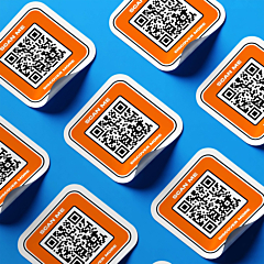 Custom QR code stickers with scan me text, printed in multiple, peel corner shown