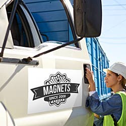 Magnetic signs example on the side of a truck with a woman employee opening the truck door. 