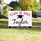 Graduation yard sign with script name design, red class of header and graduate photo displayed outdoors in front yard