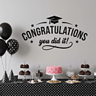Congratulations You Did It graduation wall decal applied to a gray wall above a graduation party dessert table with balloons and cake