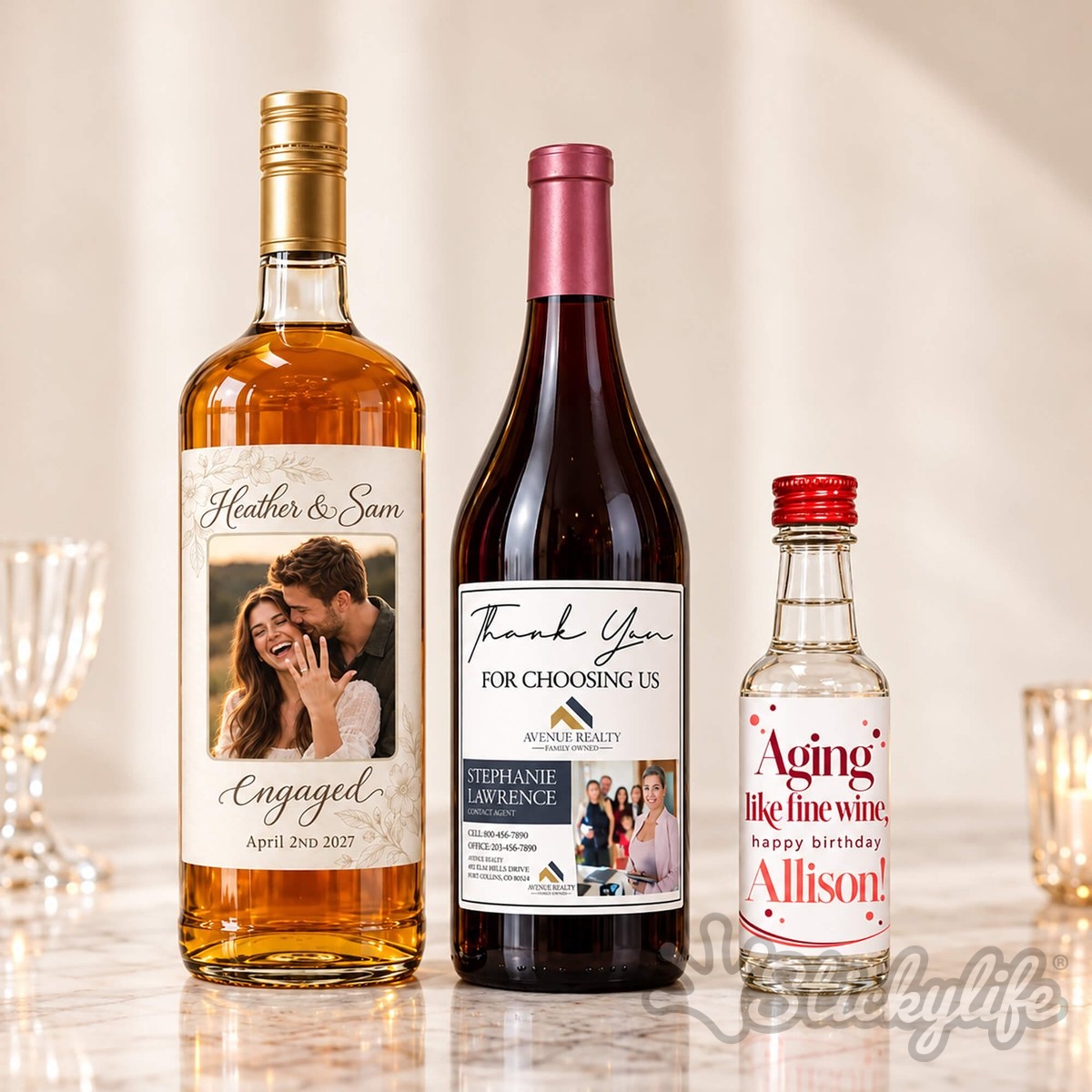 Three bottles with custom labels: a large bottle, a red wine bottle, and a mini bottle.