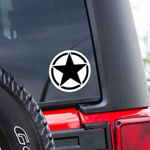 Example of a circle vinyl sticker on back of a Jeep window.