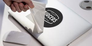 Custom Vinyl Decals being applied to a laptop 