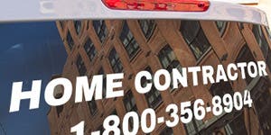 Vinyl lettering applied to the back of a truck window advertising for a home contractor along with a phone number