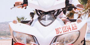 A close up view of an ATV or Snowmobile with the state required registration numbers prominently applied to the wind guard.