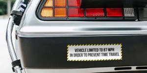 A bumper sticker applied to the back of a cars bumper